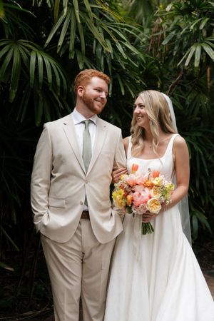 Romantic wedding portraits in a lush tropical garden setting.