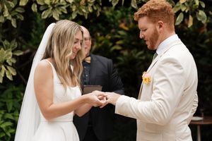 A couple sharing their first dance at an outdoor wedding reception.