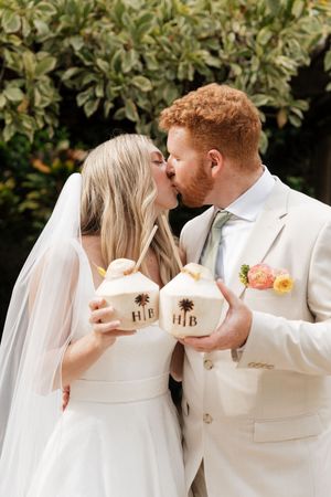 A romantic wedding photoshoot with matching 'his and hers' coffee mugs against a lush garden backdrop.