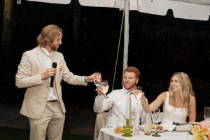 Wedding reception guests seated at tables during dinner and toasts.