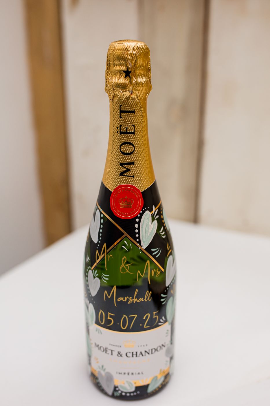Close-up shots of champagne bottles with custom date labels in a sequence.