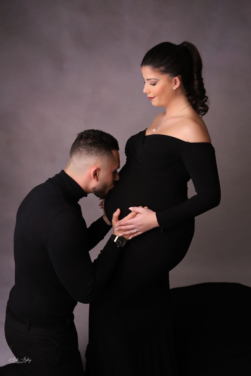 Dramatic maternity photography sequence showing couple in black attire against moody backdrop.