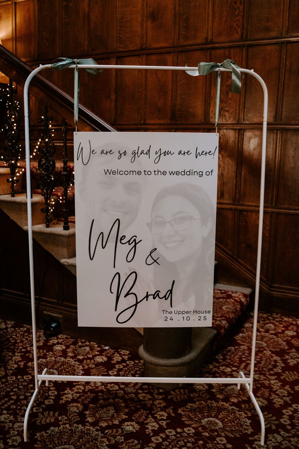 Wedding welcome signs displayed on white stands with elegant script lettering.