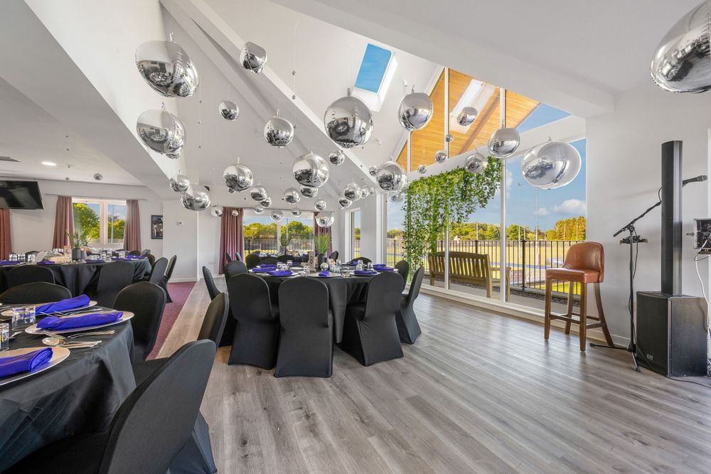 Contemporary event space with disco balls, hardwood floors and floor-to-ceiling windows.
