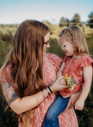 A series of tender outdoor family moments captured at sunset showing affection and connection in matching coral outfits.