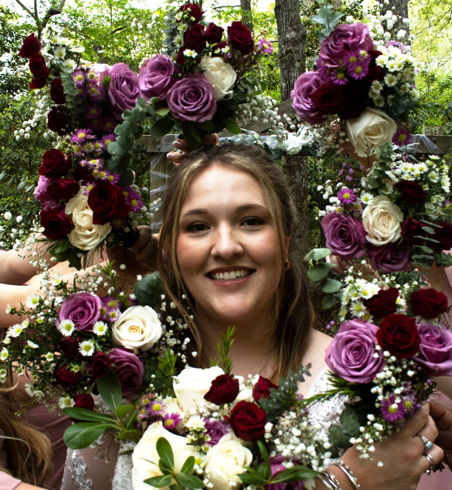 Beautiful floral crown with purple and white roses surrounded by greenery.