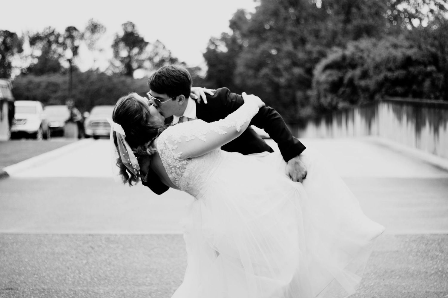Black and white artistic wedding dip pose sequence showing romantic dance movement.