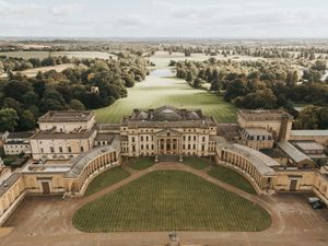 Panoramic aerial view of the Royal Crescent in Bath, showing the iconic curved Georgian architecture and manicured lawns.