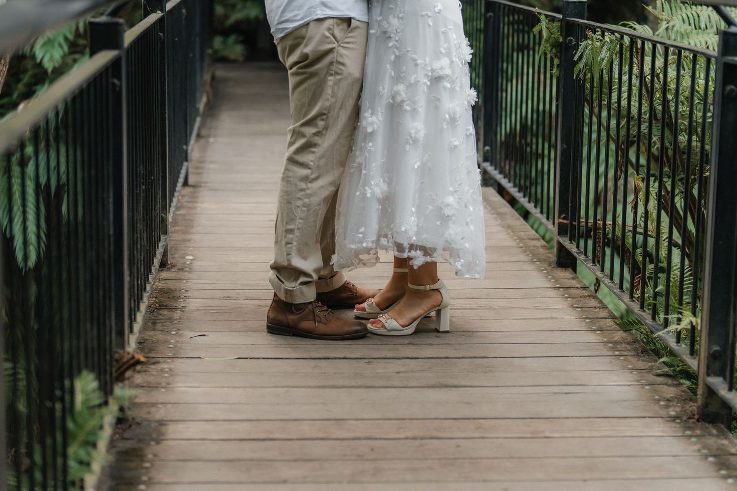 A series of connected images shows feet and boots standing at various angles on a wooden footbridge in nature.