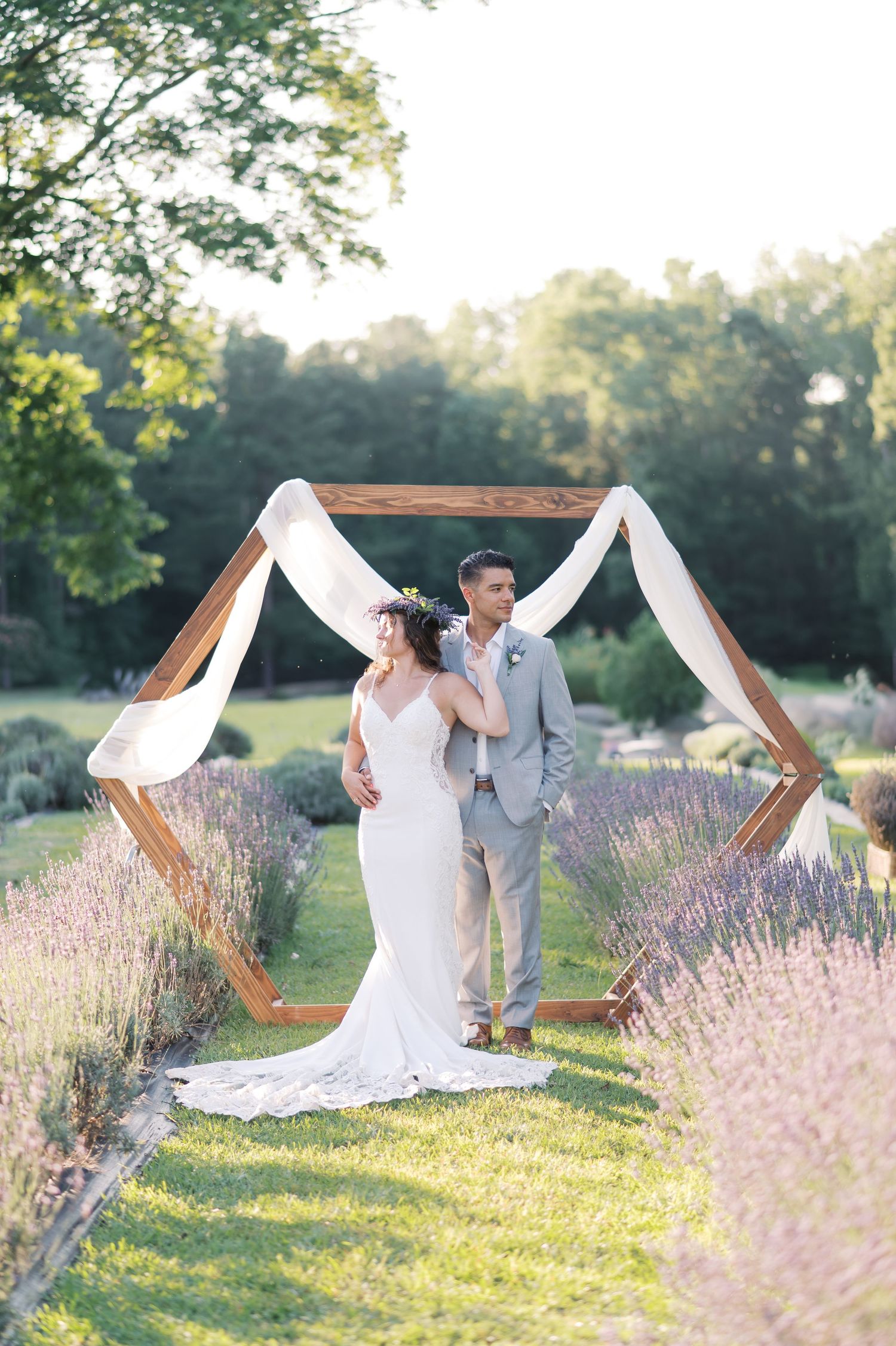 Editorial wedding pose for bride and groom, taken in a lavender field near Southern Pines NC.