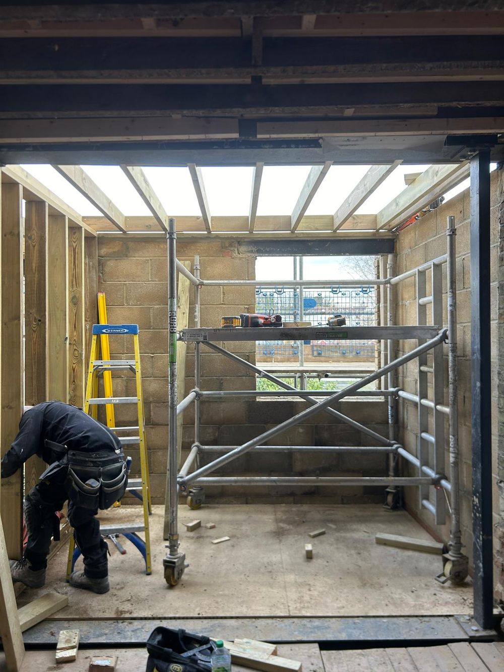 Turn-key home renovation showing a building site, scaffolding and brick work
