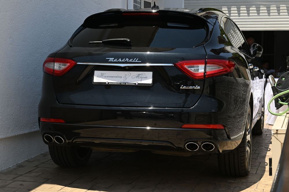 Rear view of a black Maserati Levante SUV with quad exhaust tips.