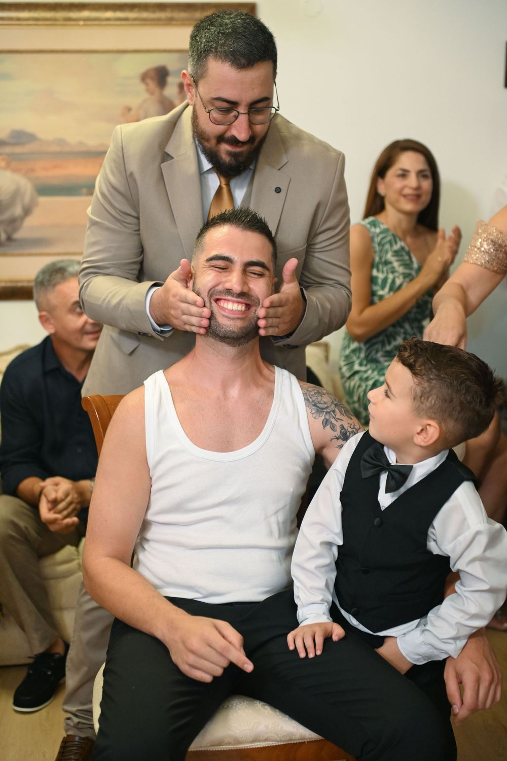 Candid wedding preparation moment with family sharing laughter and joy.