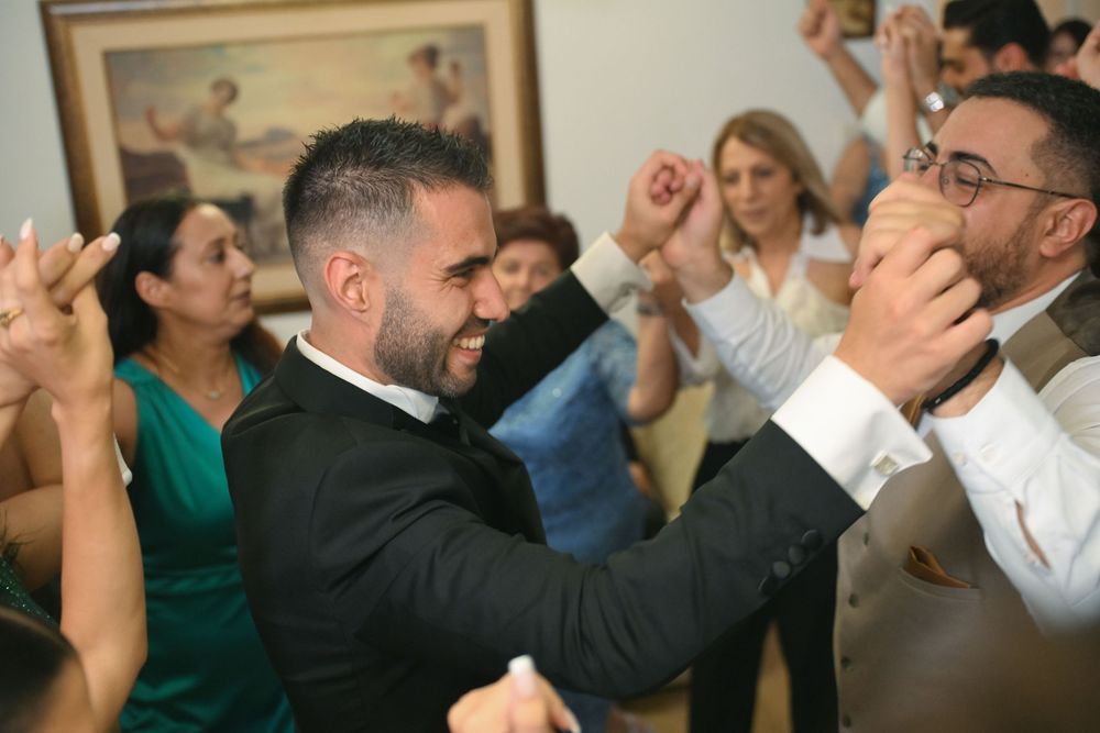 Energetic wedding reception moment with guests dancing and celebrating.