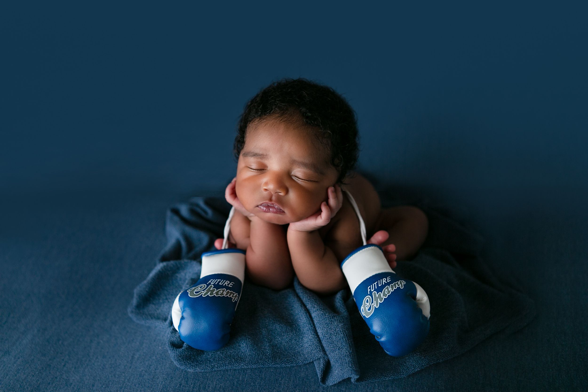 Orlando FL Newborn Photography 21 Moments Photography newborn baby boy holding boxing gloves