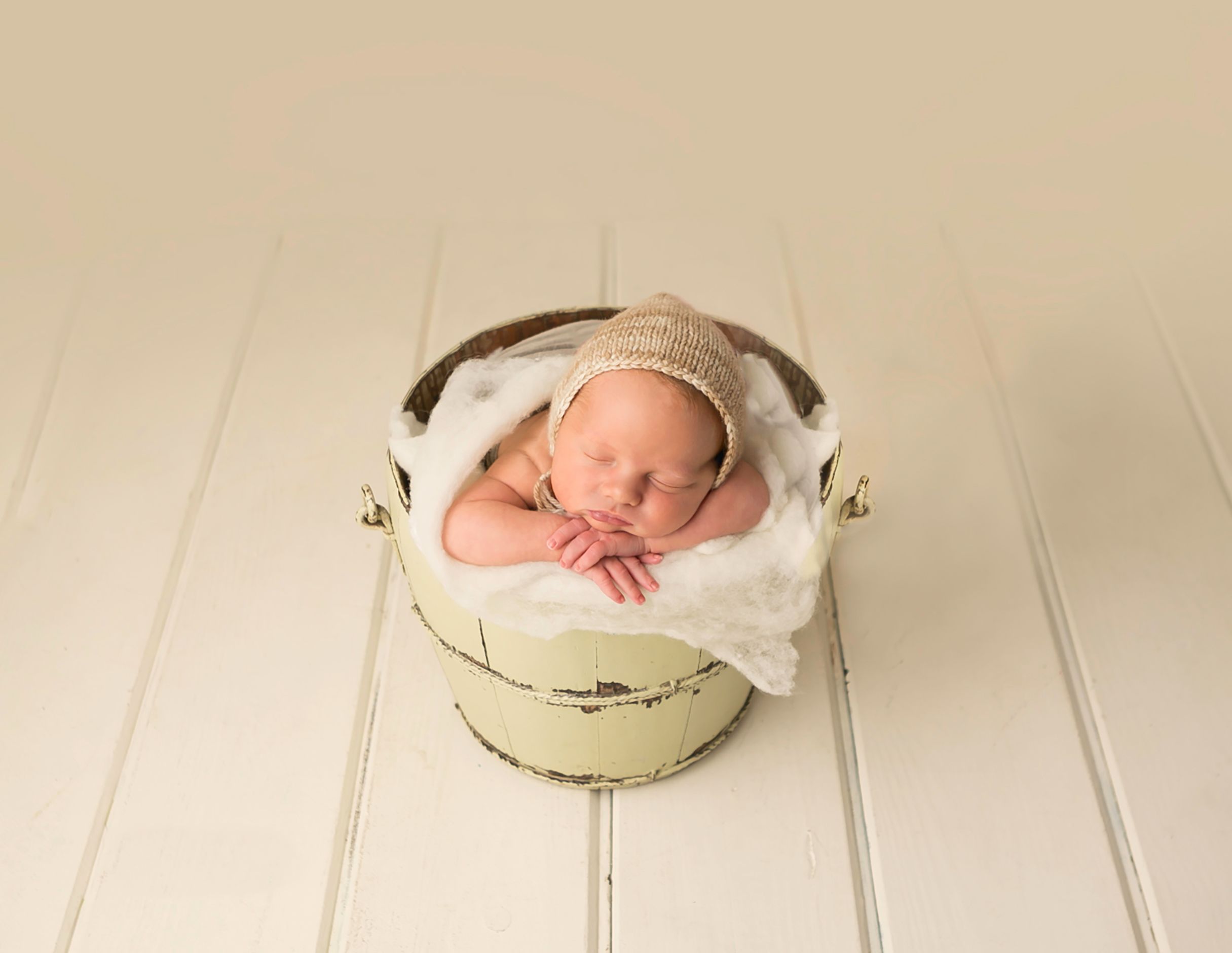 Orlando FL Newborn Photography 21 Moments Photography newborn boy sitting in a bucket prop on cream background