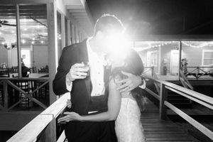 Black and white images showing silhouettes and bright light beams in an indoor venue.