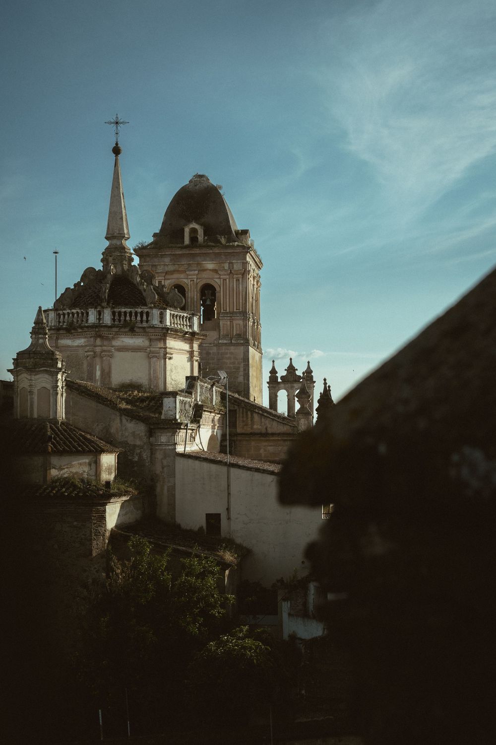 A series of dramatic low-angle shots showing the architectural details of a historic Spanish colonial church against a moody sky.