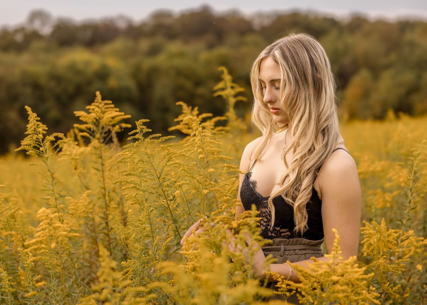 Sunset portrait photography in a field of golden wildflowers.