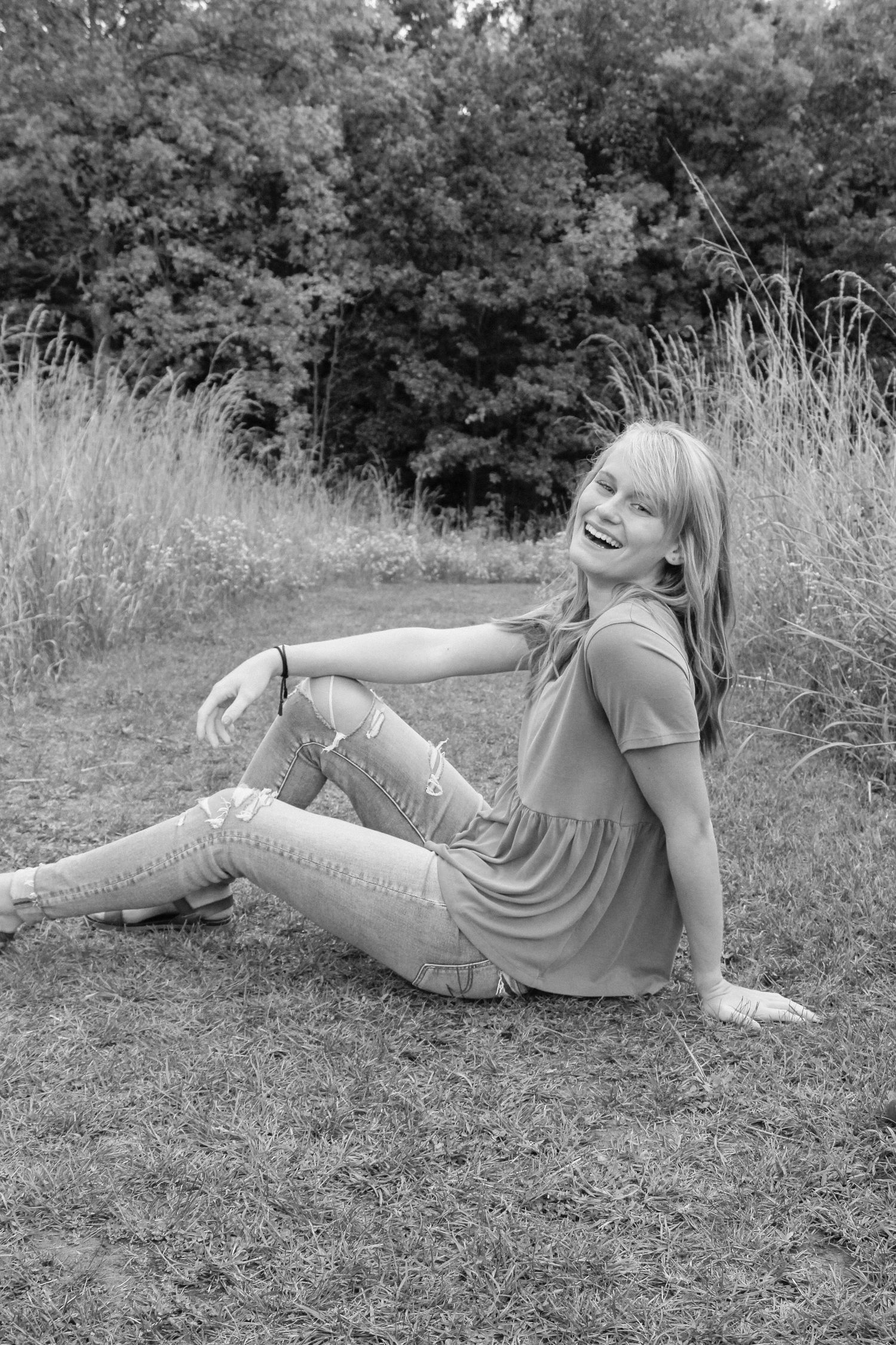 Senior girl in a field during golden hour at Grand Ravines Park.