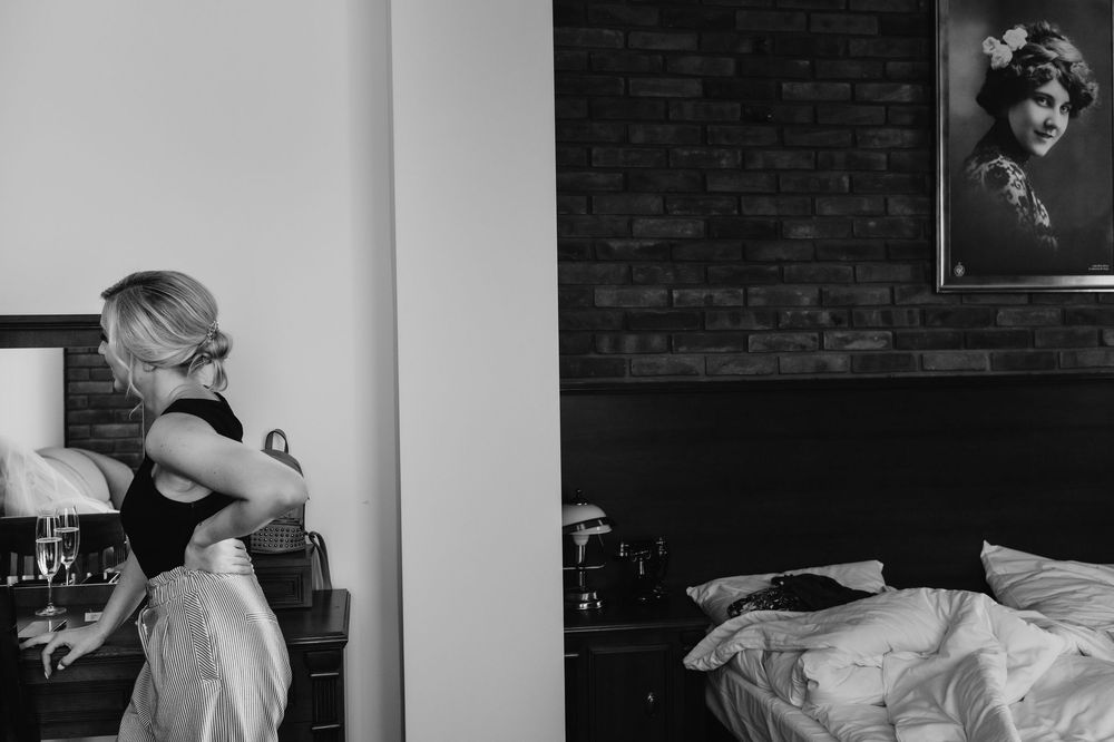 Black and white film strip showing wedding preparations in an interior space with moody lighting.