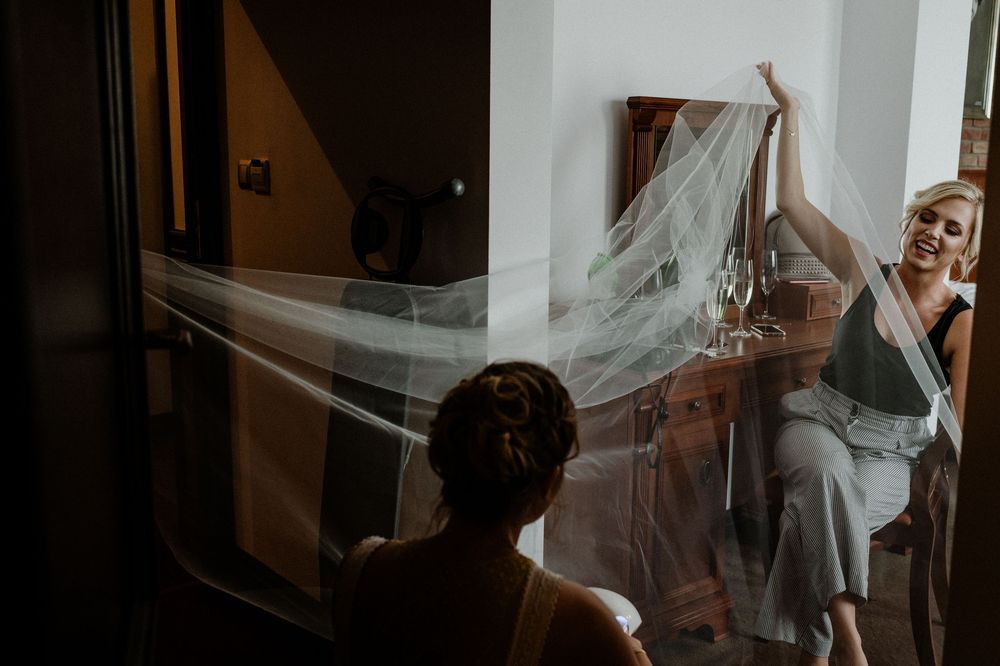 Natural light streaming through windows in a room during wedding preparations.