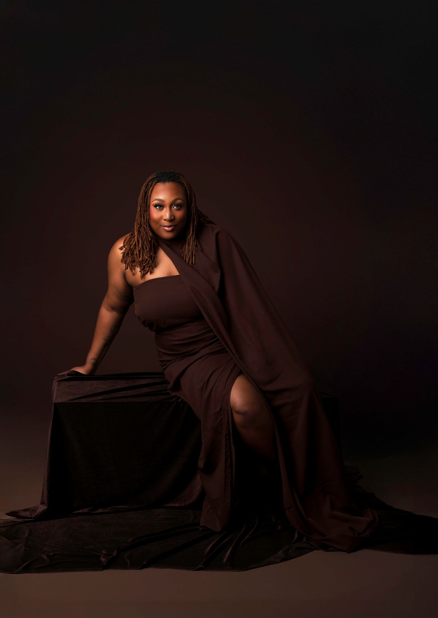 Artistic portrait series in brown tones showing a figure in flowing fabric against a dark background.