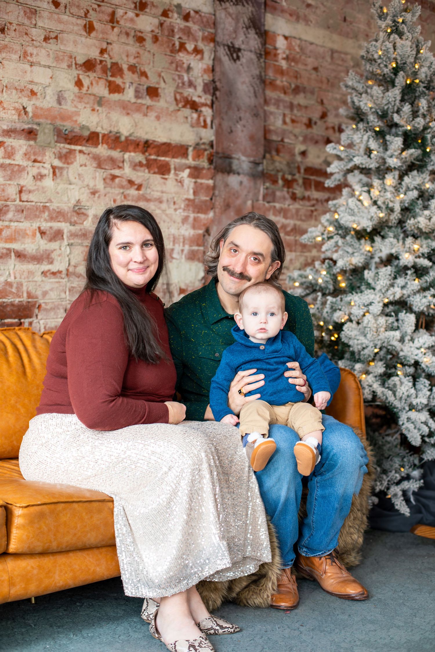 Cincinnati Christmas mini sessions featuring mom dad and baby capturing classic holiday family portraits, festive decor, and joyful seasonal