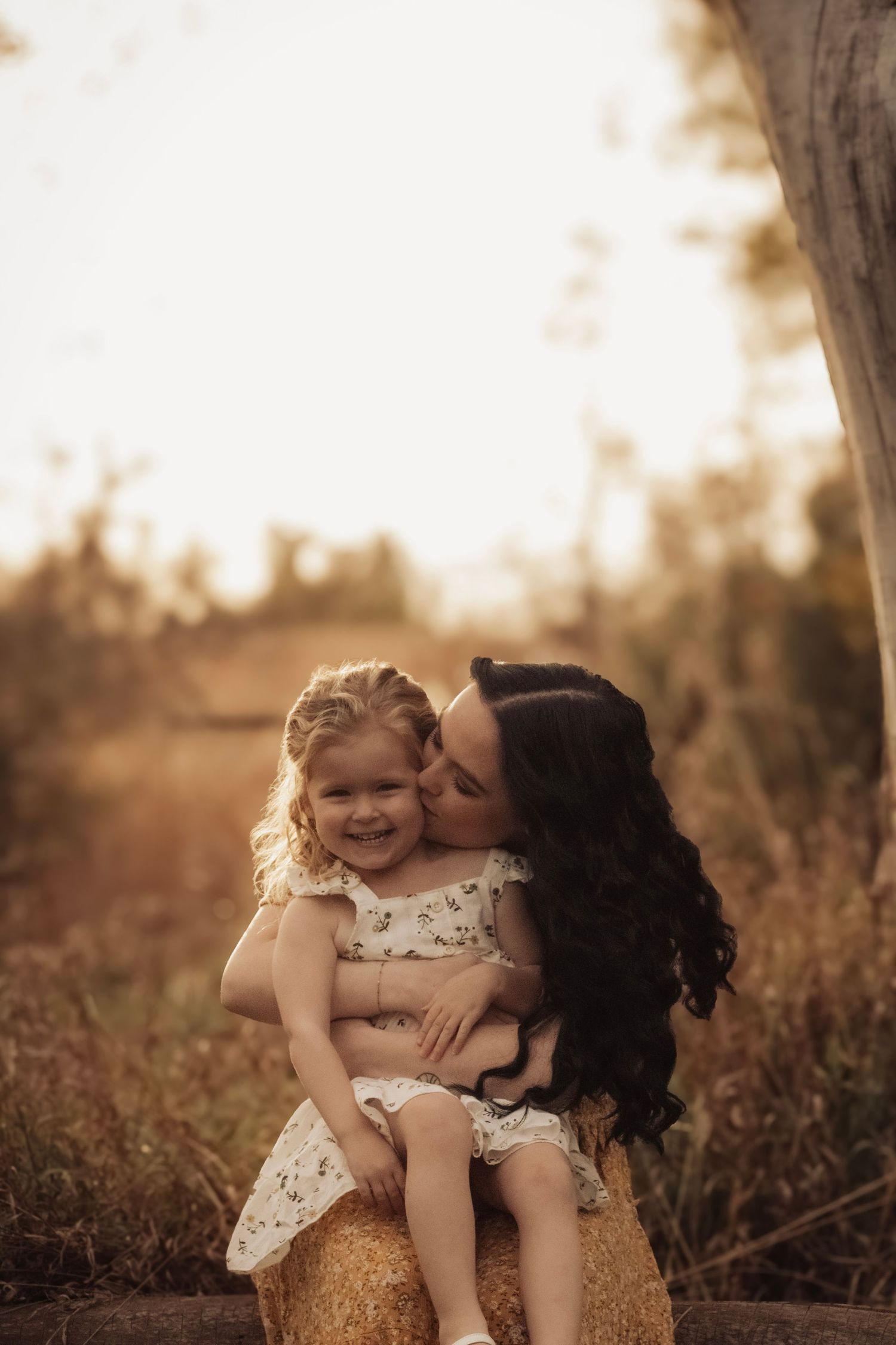 A tender outdoor portrait session captured in warm autumn lighting.