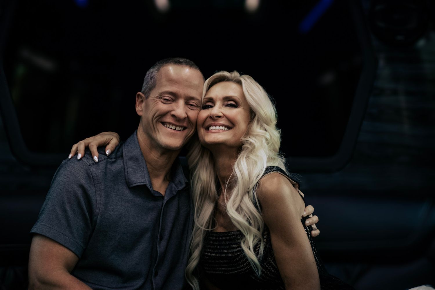Intimate couple portrait session with dramatic low-key lighting.