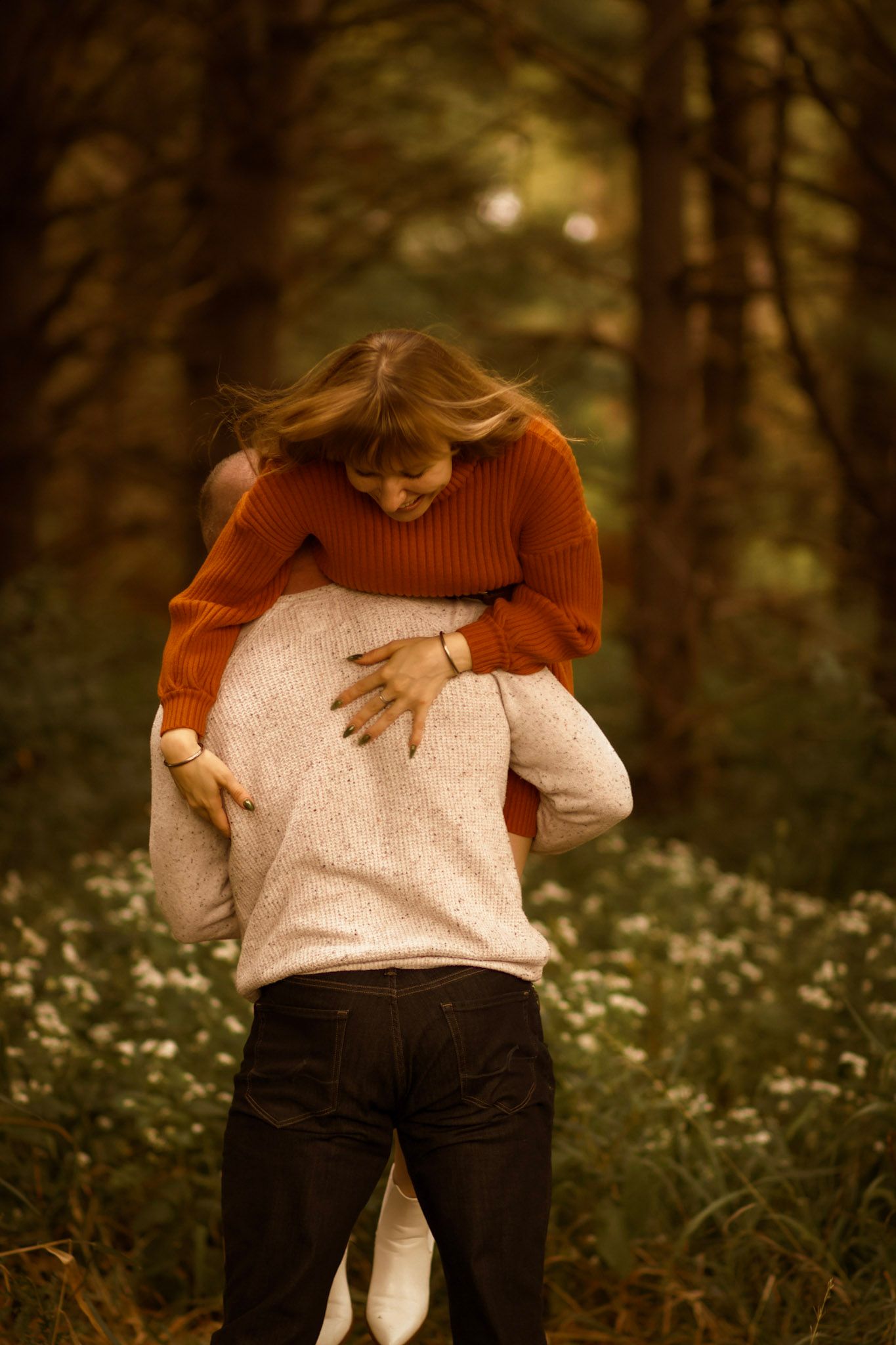 A playful moment captured between two people in a field of wildflowers.