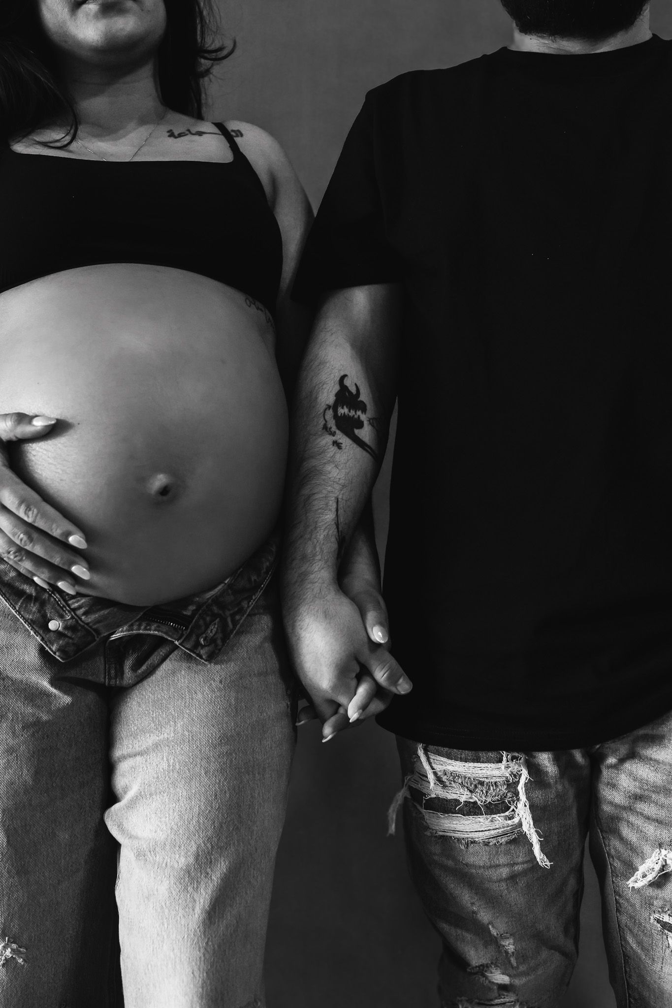 Black and white maternity photo series showing a growing baby bump in progressive stages.