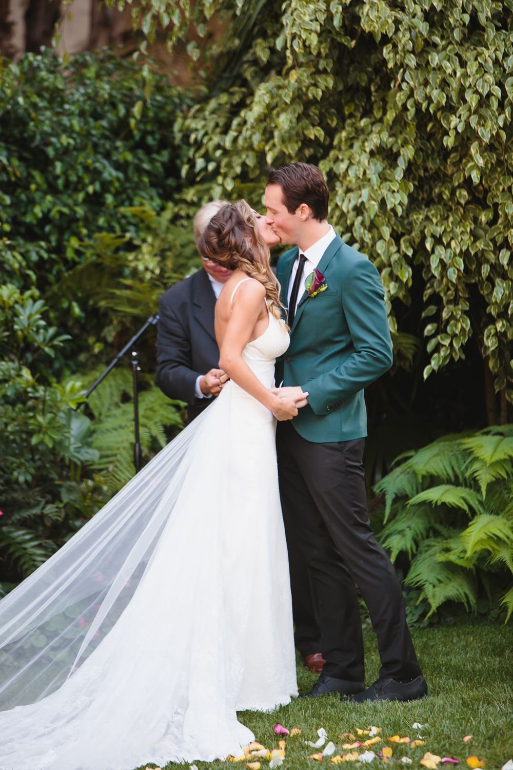 Romantic first look sequence between newlyweds in a lush garden setting.