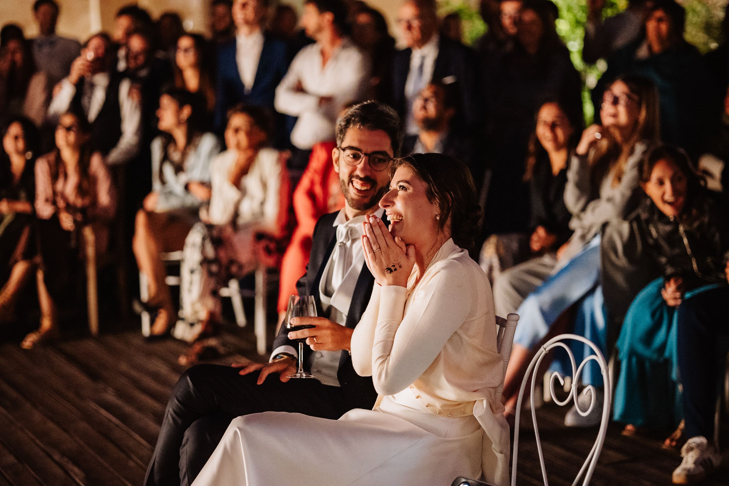 Candid moments captured at a wedding reception show guests enjoying themselves on the dance floor and at tables.