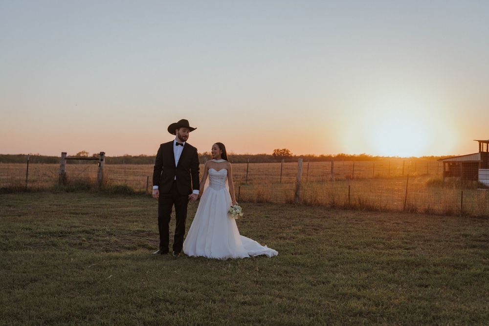 Romantic sunset wedding photos in rural field with golden hour lighting.