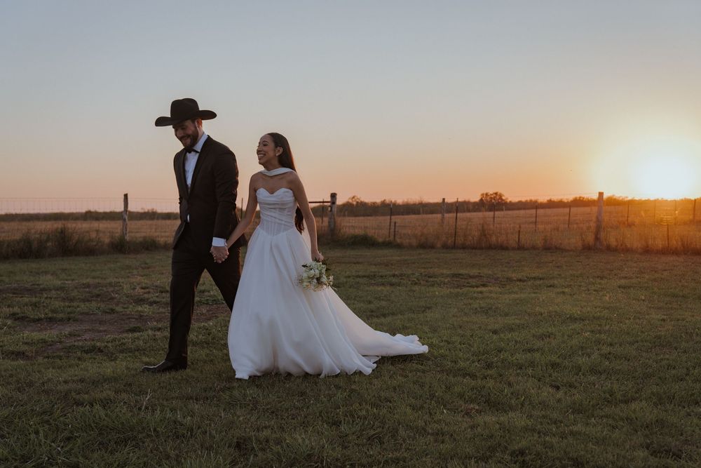 Sunset wedding portraits in rustic farm setting with dramatic evening light.