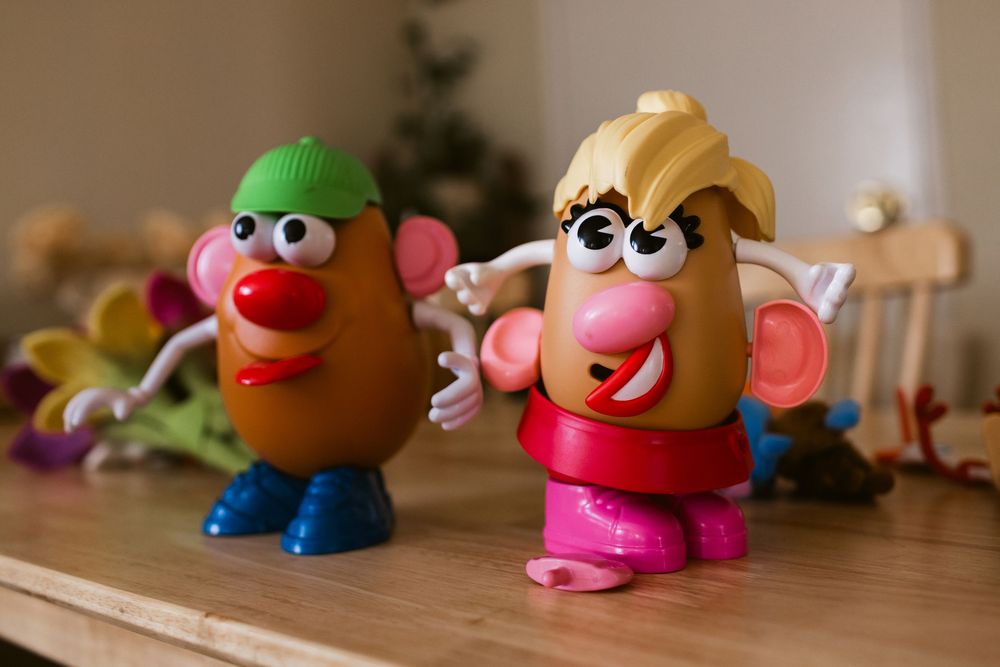 Mr. and Mrs. Potato Head stands on an ash wooden table at a home in Harvard, Massachusetts as a detail shot for a family photo shoot.