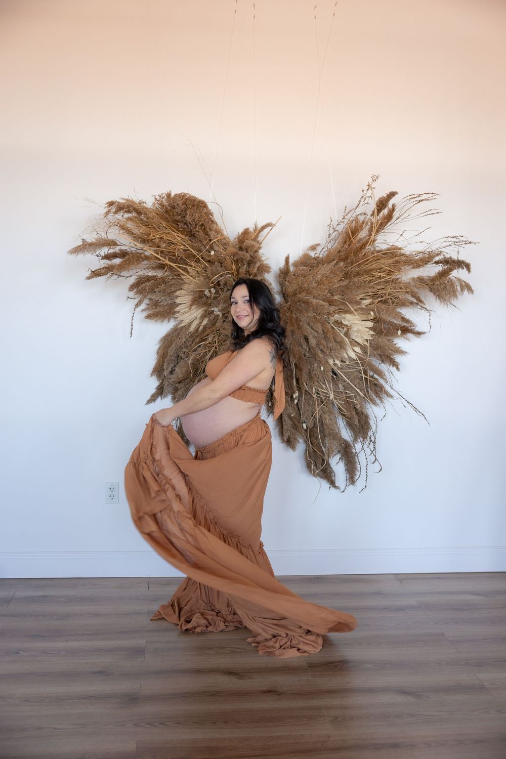 Artistic dance sequence with flowing brown dress and dried pampas grass movement.
