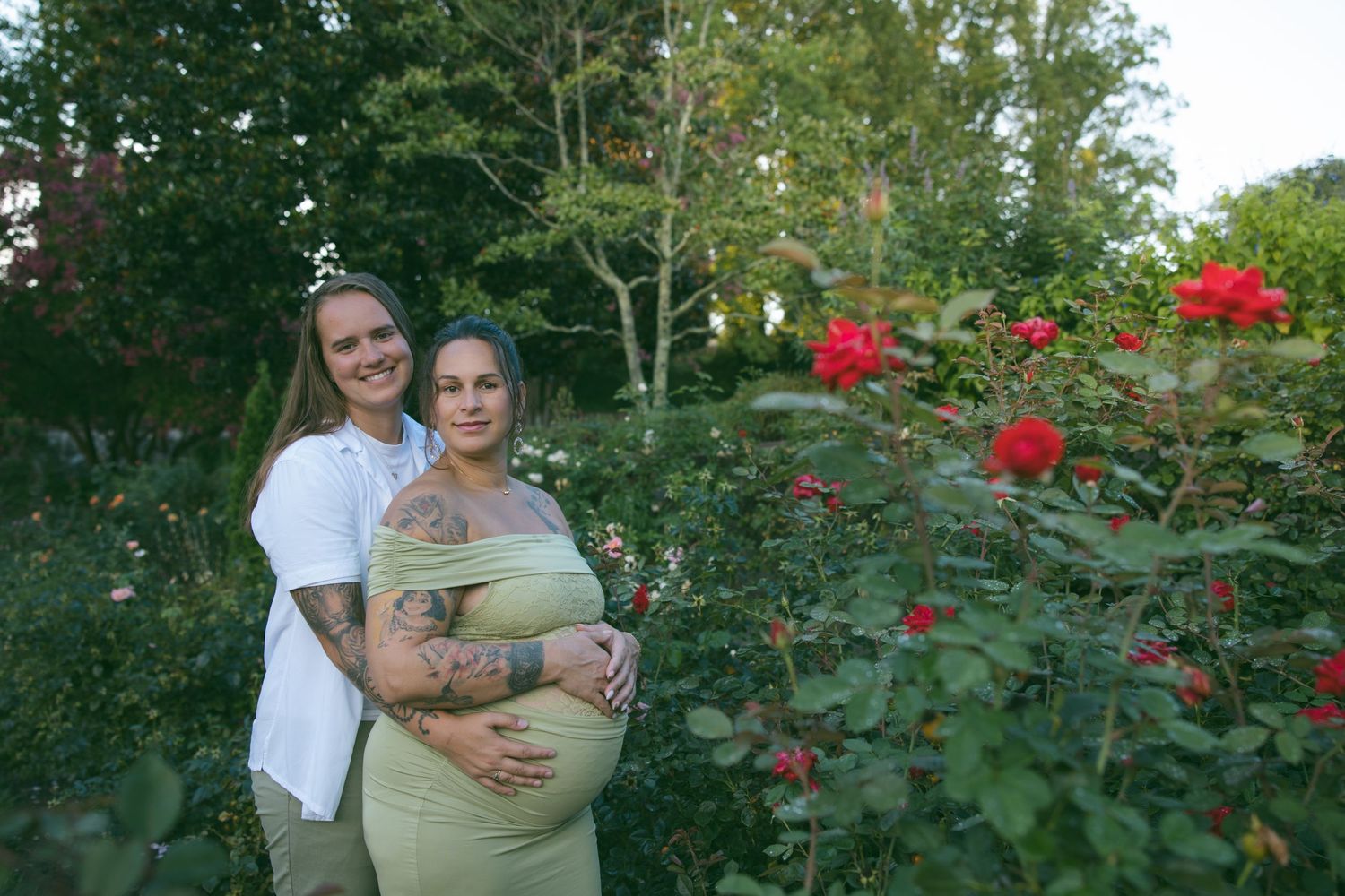LGBTQ couple holding hands at a romantic proposal location Biltmore Estate garden in Asheville, North Carolina