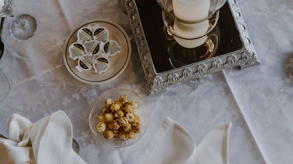 Close-up details of wedding table decorations with delicate lace and crystal accents.