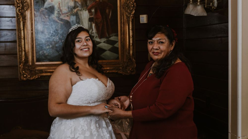 Wedding celebration scene with emotional interactions in a classically decorated venue.