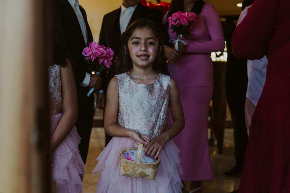 Wedding party members in purple dresses gather during an indoor celebration.