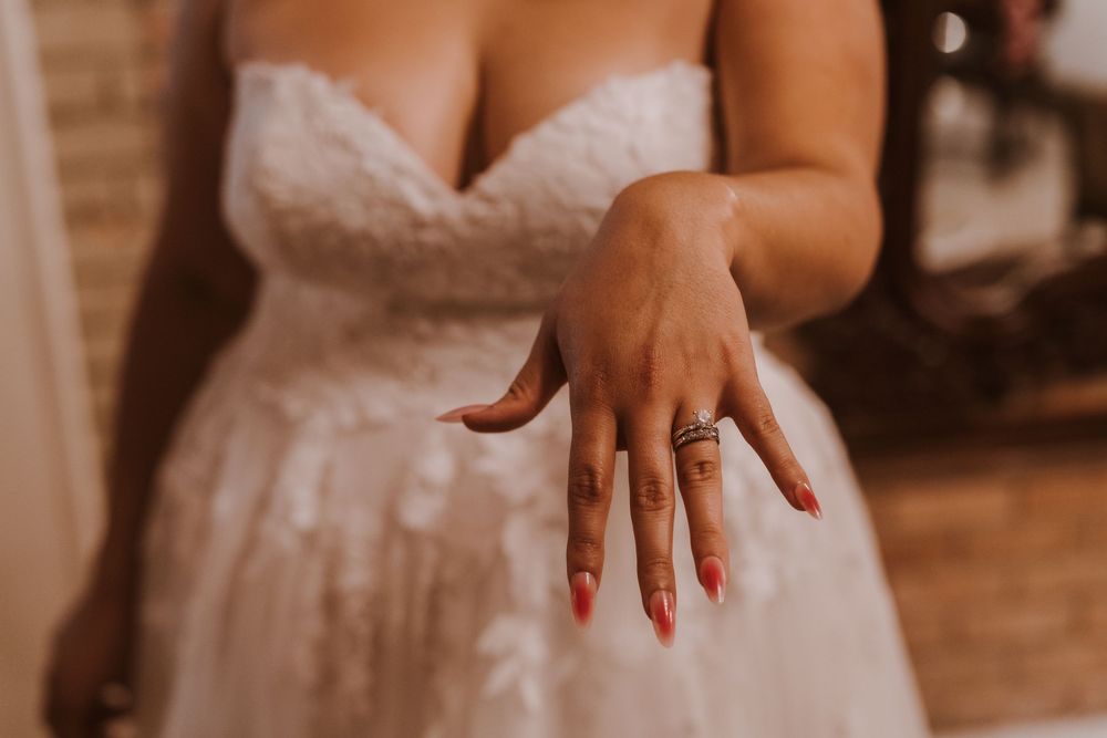 Close-up detail of bridal gown with lace and beading.