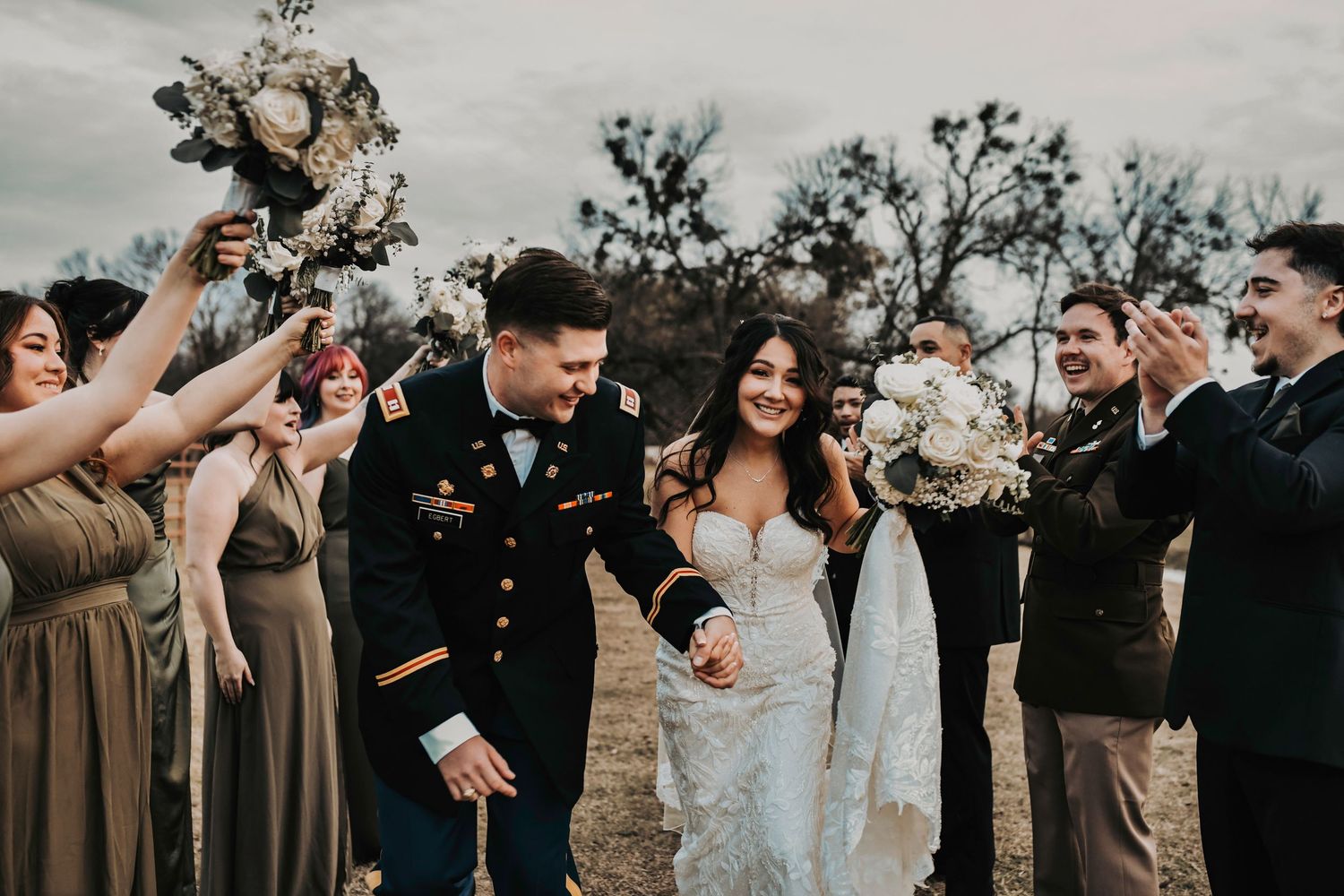 Bridesmaids and groomsmen joking around for a lively, unposed wedding party shot.