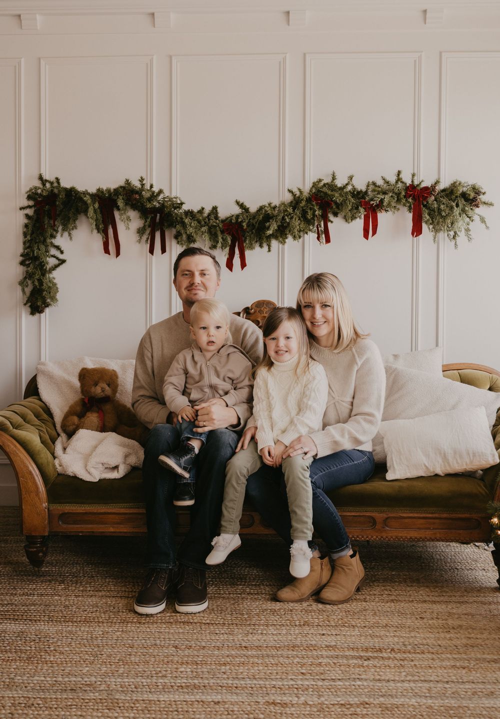 A series of five connected photos showing a family sitting on a brown leather couch with holiday garland decor above.