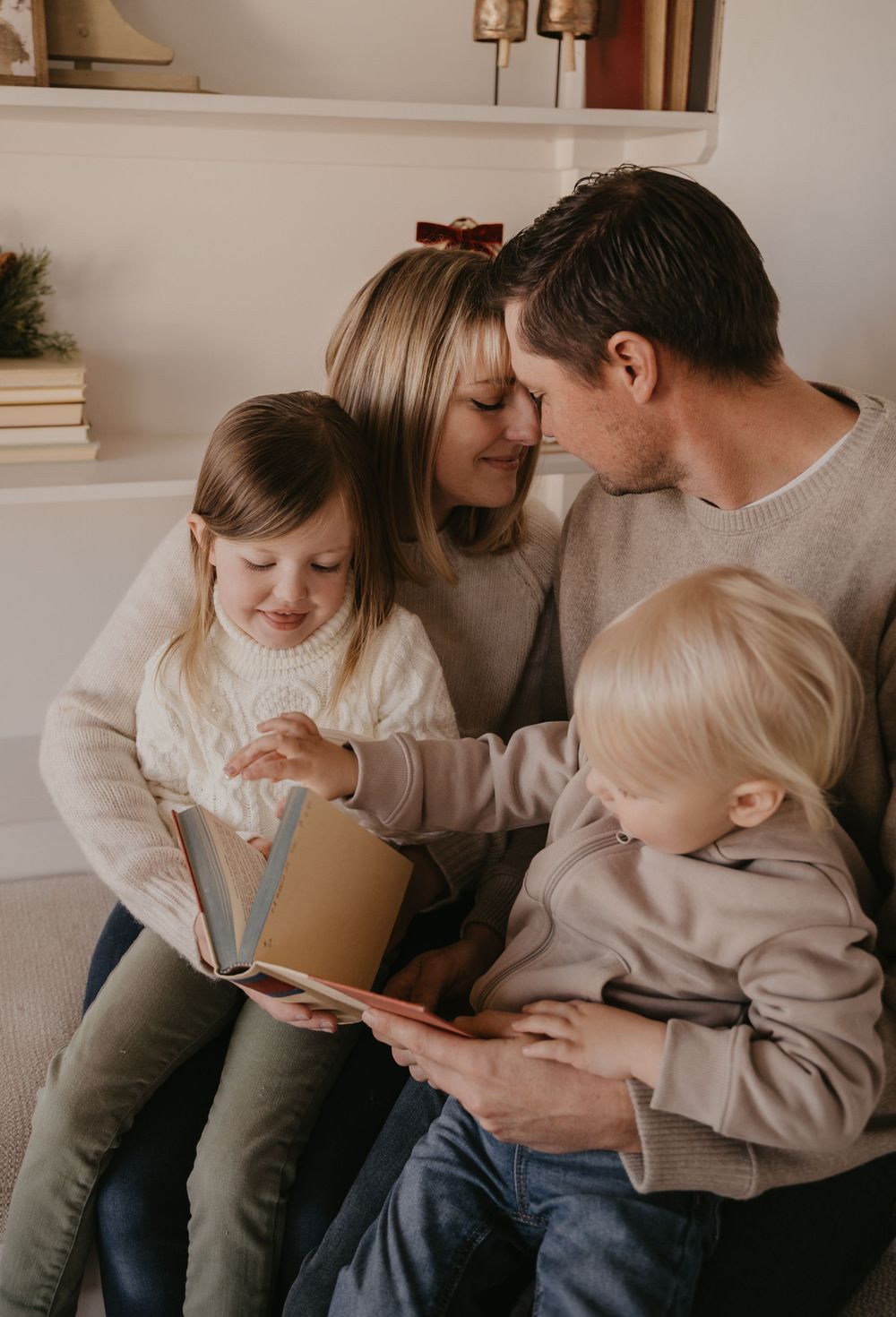 A family shares tender moments together on a couch in a series of intimate lifestyle photographs.
