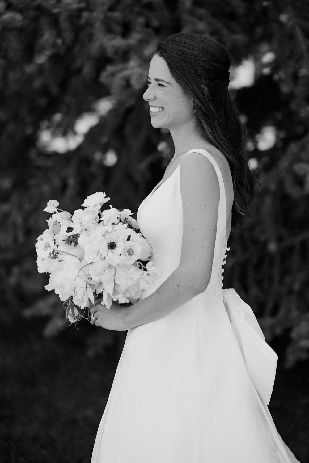 A sequence of elegant wedding photos featuring a white bridal bouquet and flowing dress against a dark background.