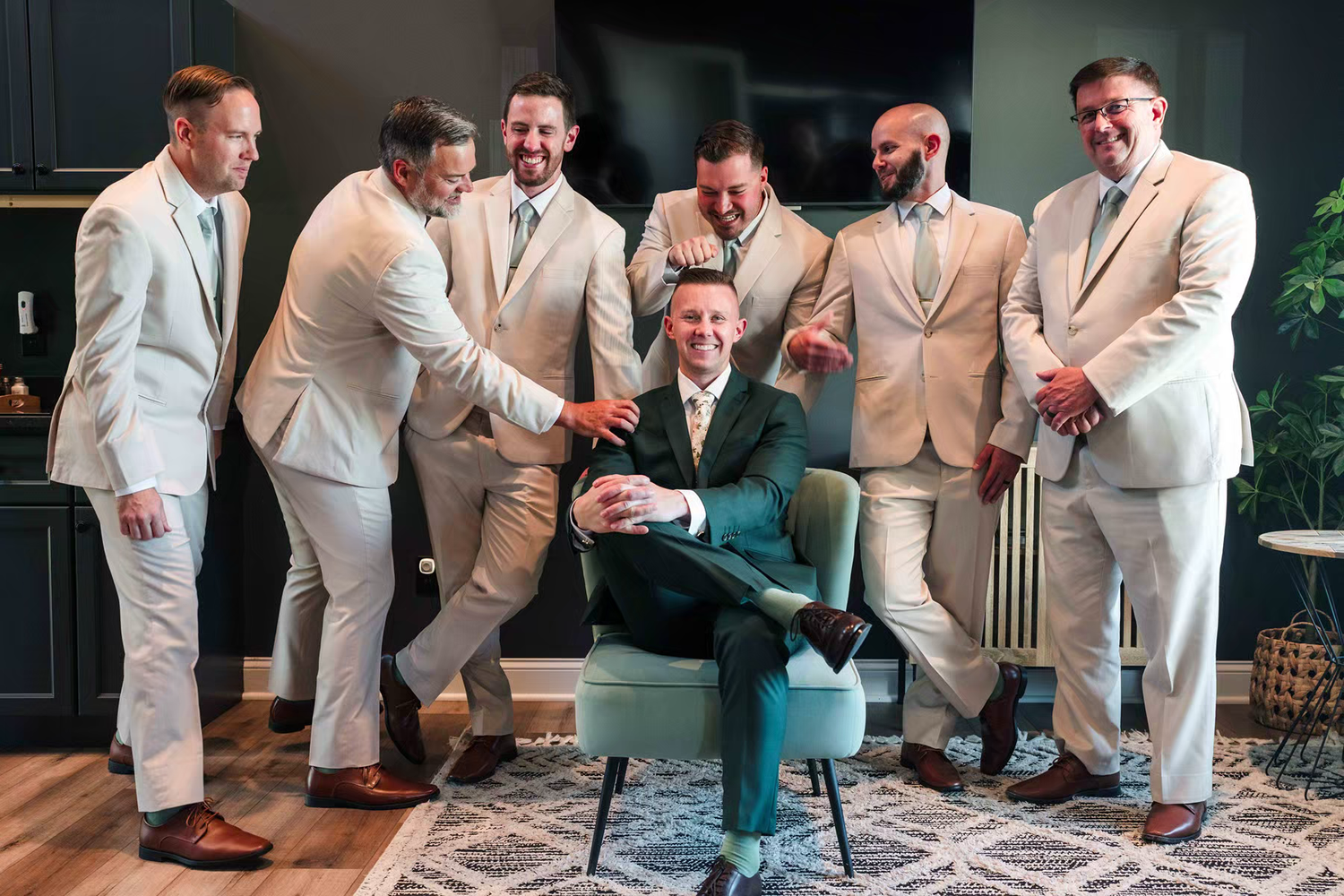 groomsmen wearing matching beige suits gather together in Retreat 21 Wedding Venue