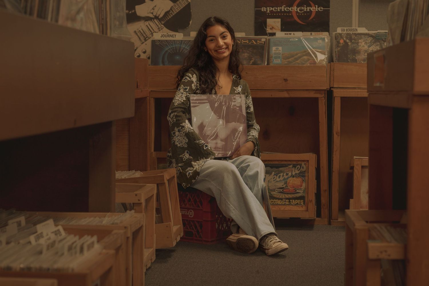 High School senior photo session at record store, 4,000 Holes in North Spokane, WA. Posing on crate with The Smiths vinyl.