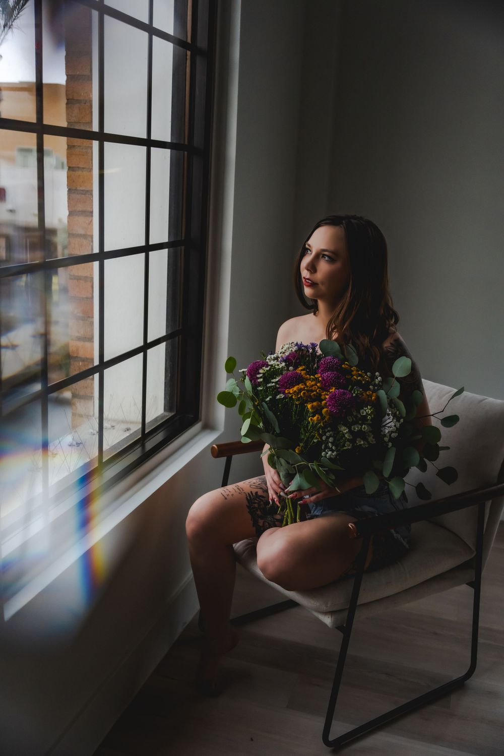 Celebrate natural beauty with bohemian boudoir; denim, wildflowers, and romantic charm for a self-love journey.